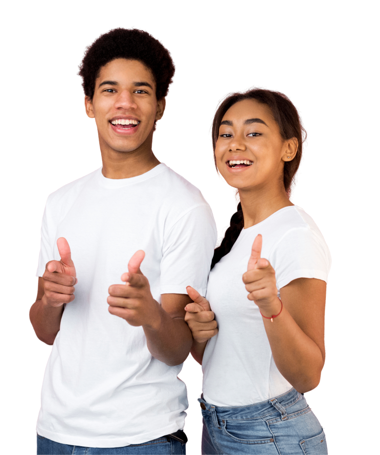 Two people in white t-shirts smiling and pointing at the camera with both hands.